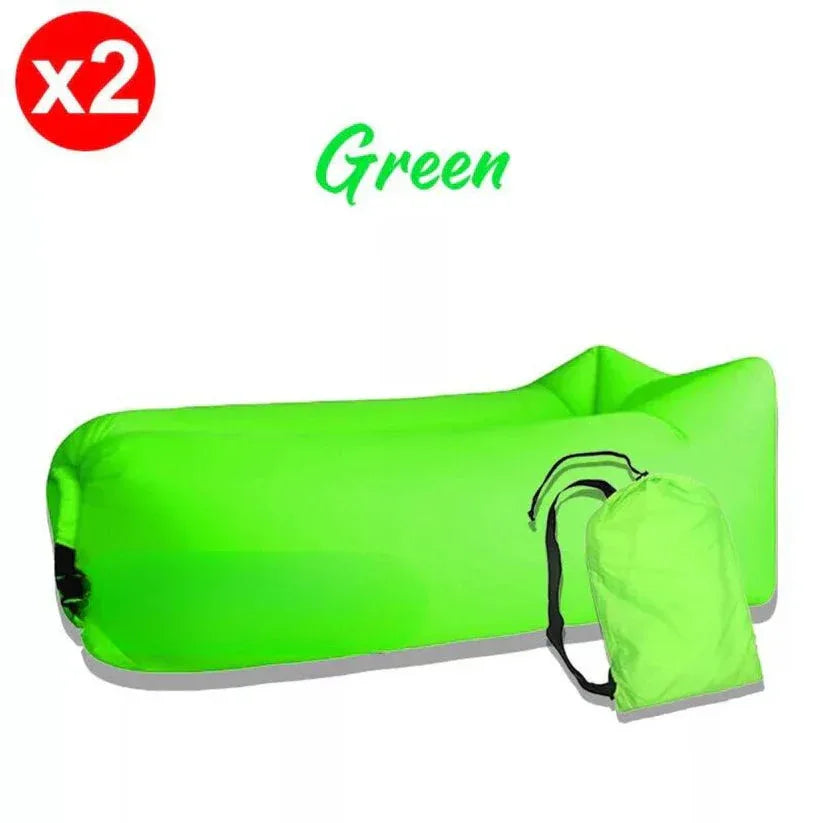 Green inflatable air bag with carrying pouch on a white background