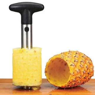 Pineapple peeler with a partially peeled pineapple on a wooden surface