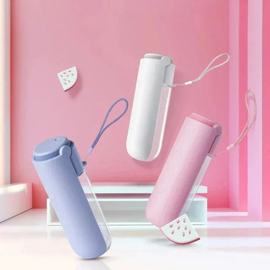 Three portable hand dryers in different colors on a pink background