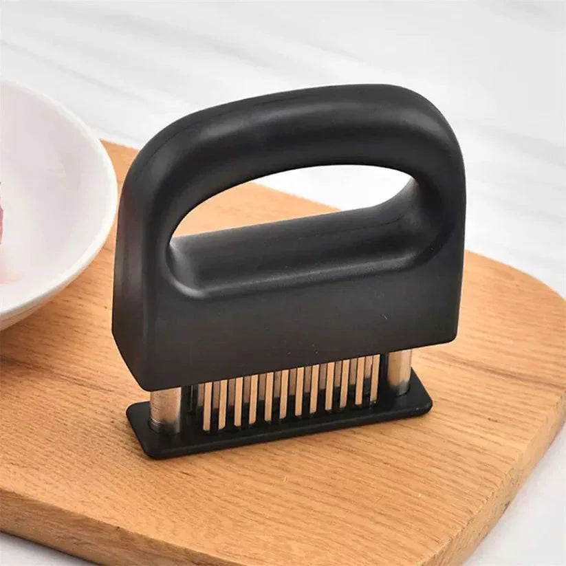 Black meat tenderizer on a wooden cutting board with a white background