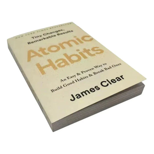 Book titled 'Atomic Habits' by James Clear on a white background