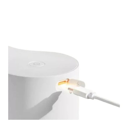 White electronic device with a cable plugged into it on a white background