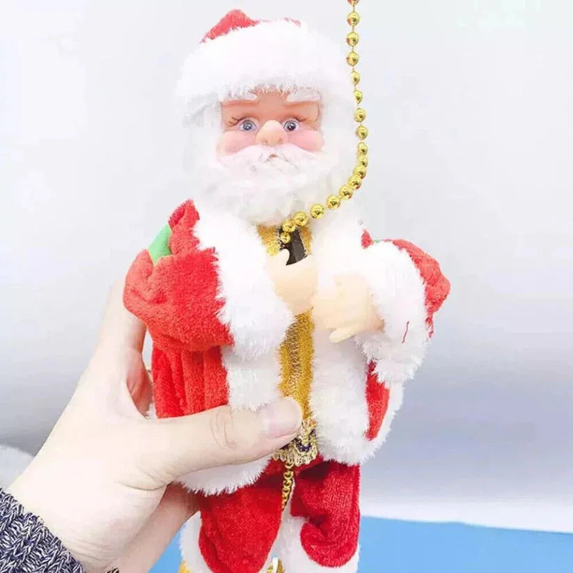 Hand holding a small Santa Claus figurine with a plain background