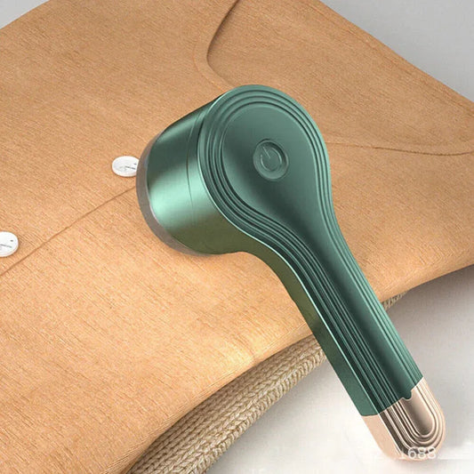 Green handheld vacuum cleaner on a wooden surface