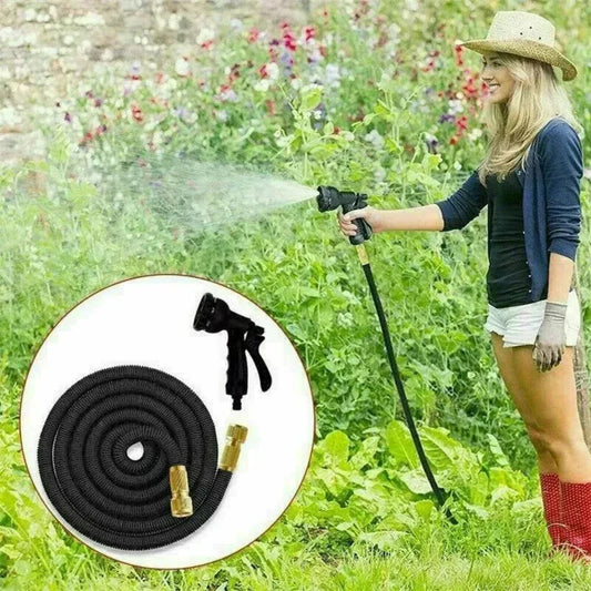 Woman using a garden hose with a spray nozzle in a garden setting