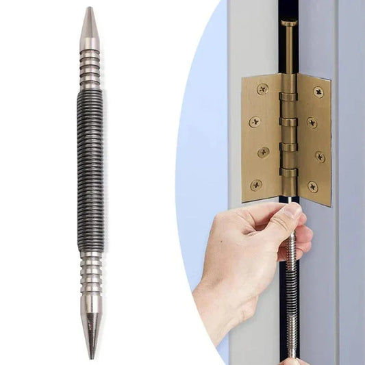 Metallic pen with a textured grip held by a hand next to a door hinge.