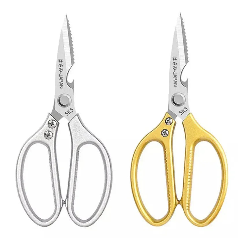 Pair of scissors with silver and gold handles on a white background