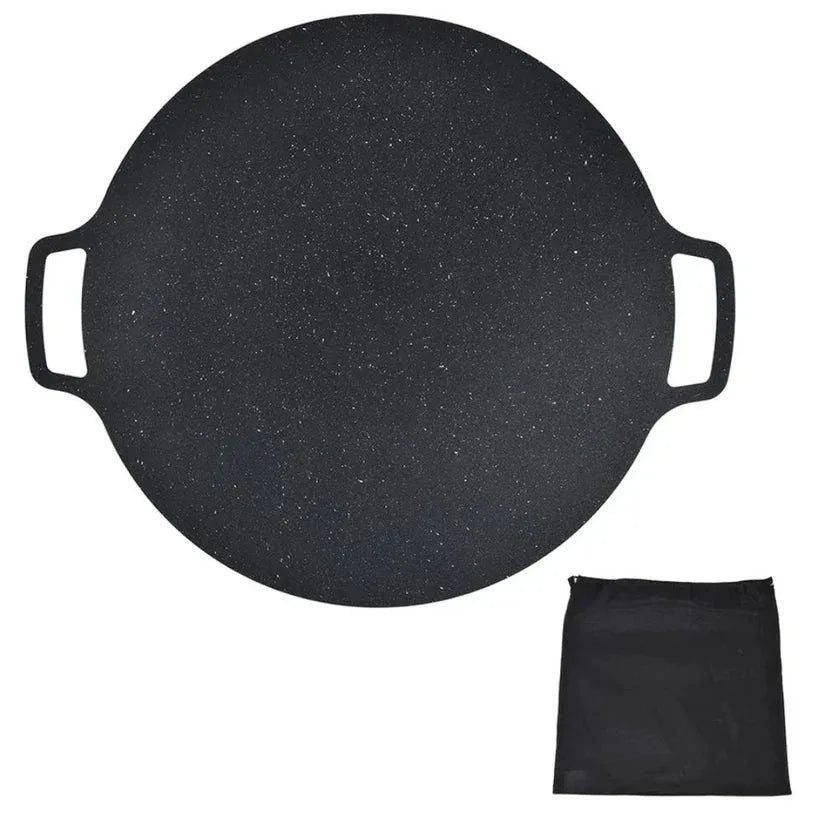 Round black griddle with handles and a matching black pouch on a white background