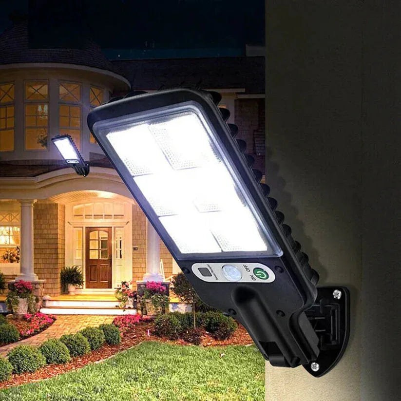 Solar wall light on a house exterior with a well-lit entrance.