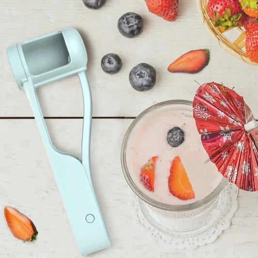 Light blue fruit peeler next to a glass of yogurt with fruit on a wooden surface