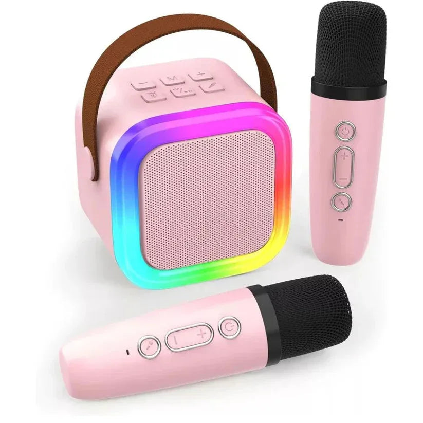 Pink karaoke machine with rainbow lights and two microphones on a white background