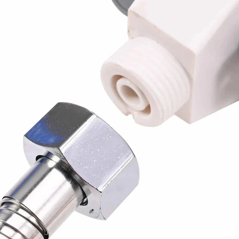 Close-up of a metallic fitting and white cylindrical object on a white background