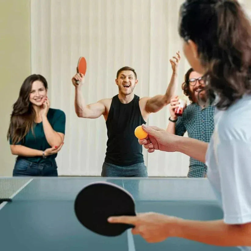 Group of friends playing table tennis indoors