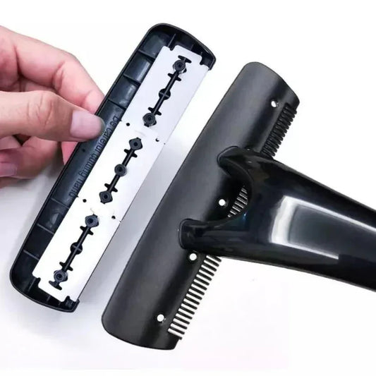 Black hair dryer with a comb attachment held by a hand on a white background
