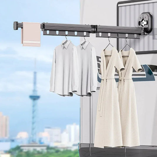 Clothes hanging on an outdoor clothesline with a cityscape in the background