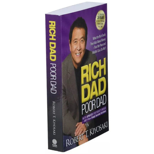 Book titled 'Rich Dad Poor Dad' with a purple cover featuring a person's face.