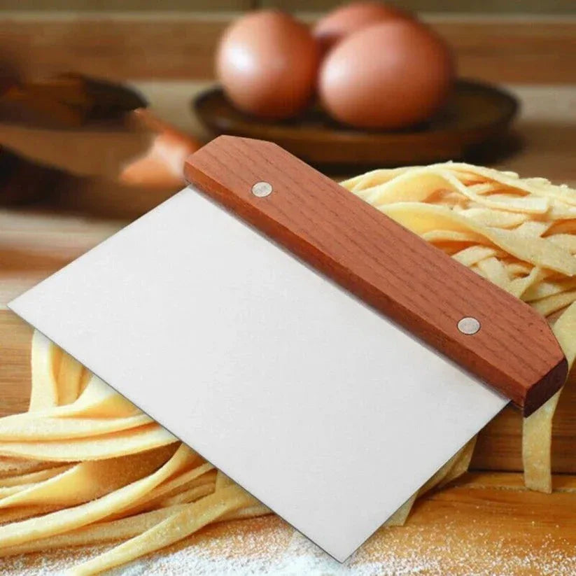 Wooden pasta cutter with fresh pasta on a wooden surface