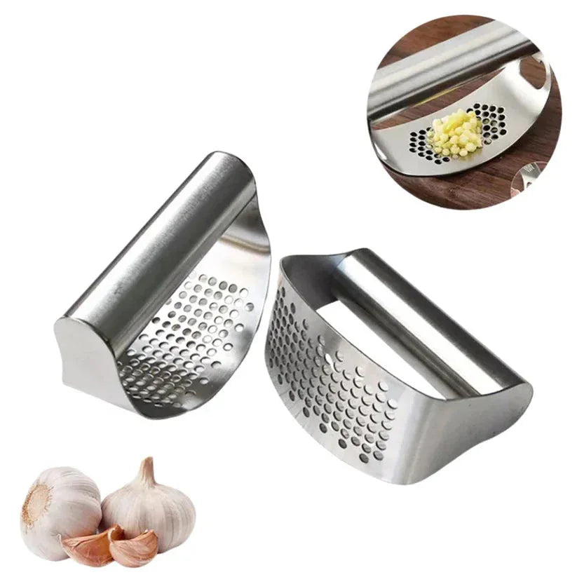 Stainless steel garlic press with garlic and crushed garlic on a white background
