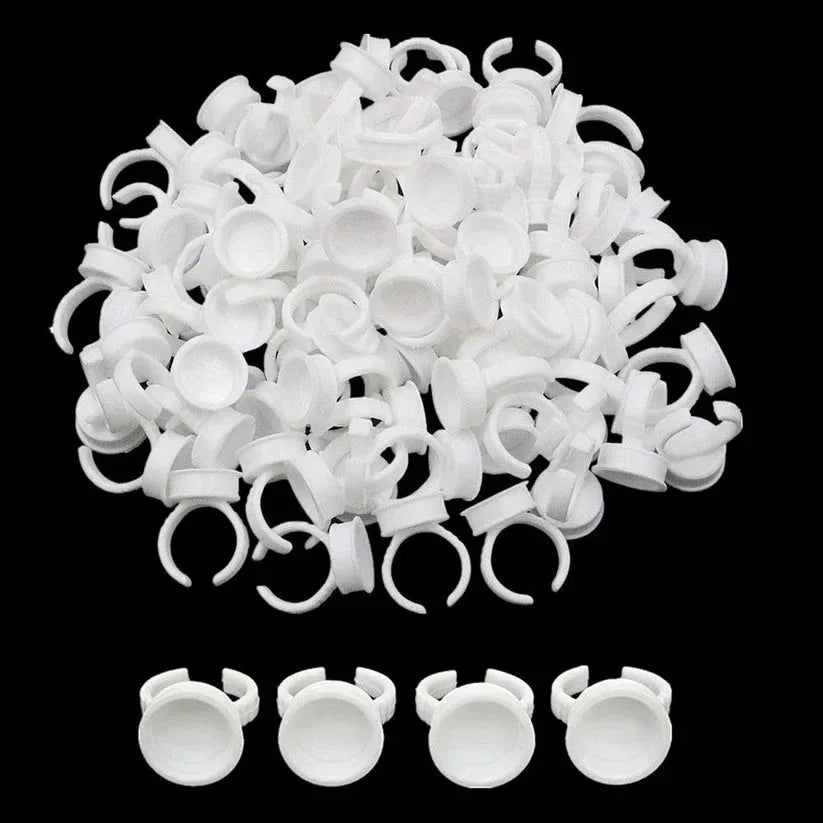White plastic earbud tips on a black background