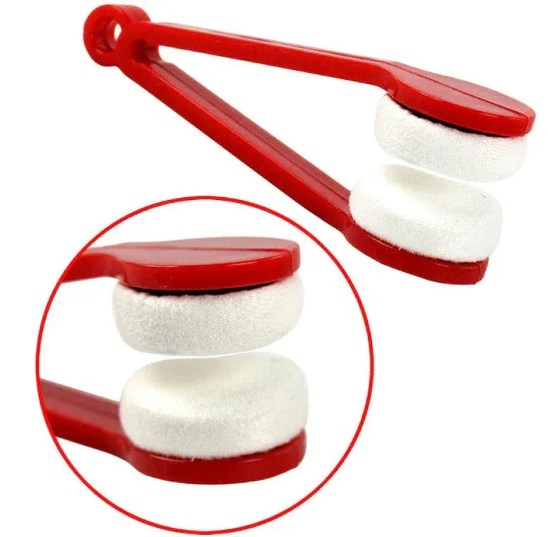 Red tool with white circular pads on a white background

