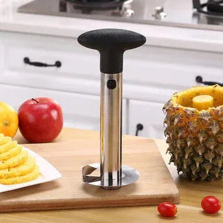 Kitchen tool on a cutting board with fruits and vegetables in the background


