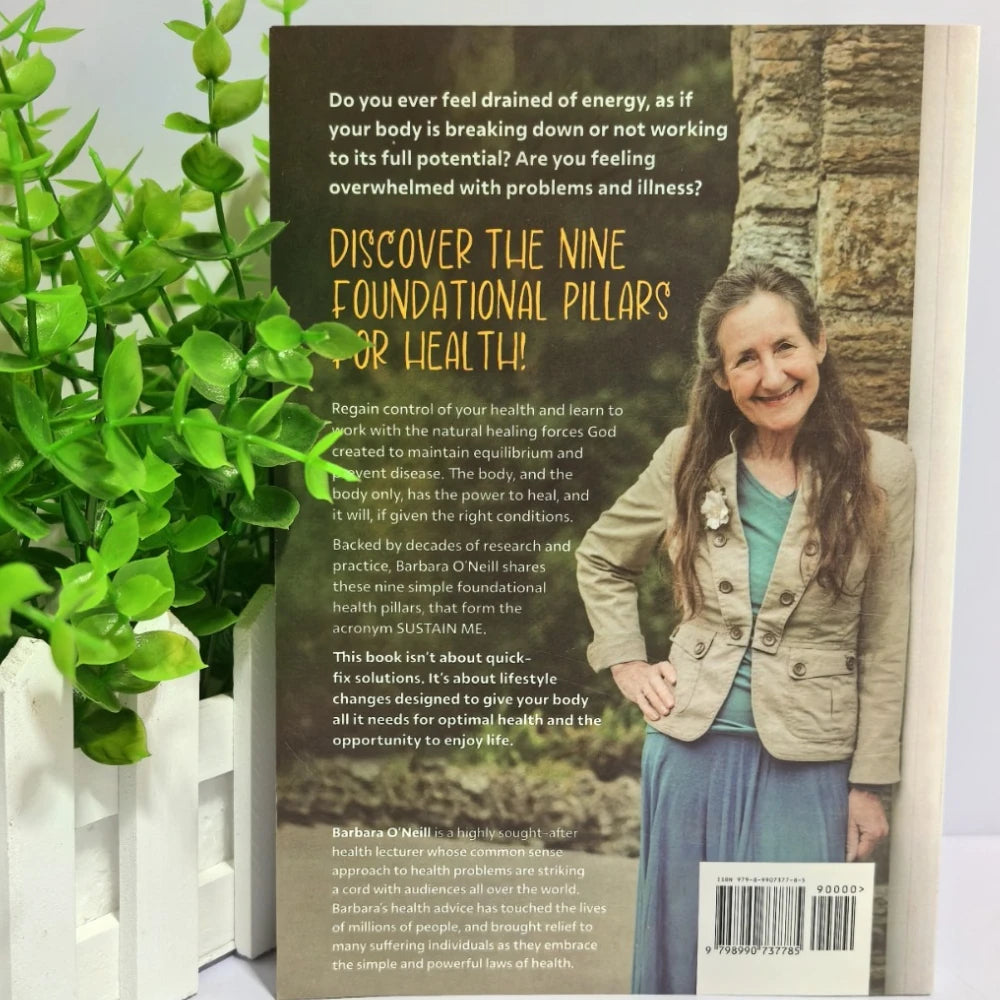 Book cover with a woman standing outdoors, text about health pillars, and a plant in the background

