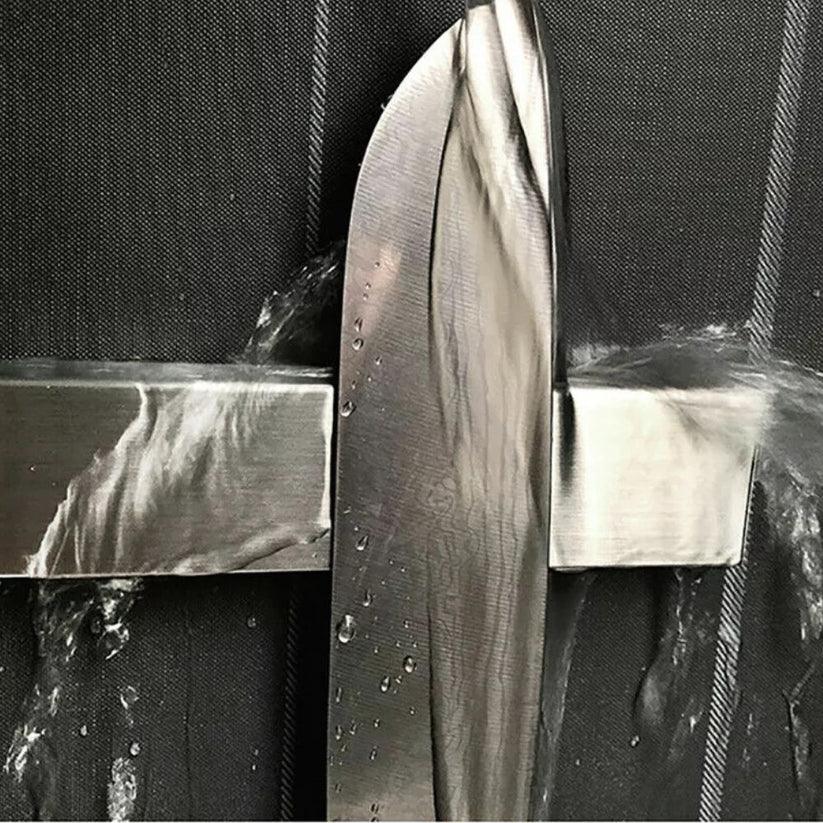 Close-up of a metallic object with a textured surface on a black background

