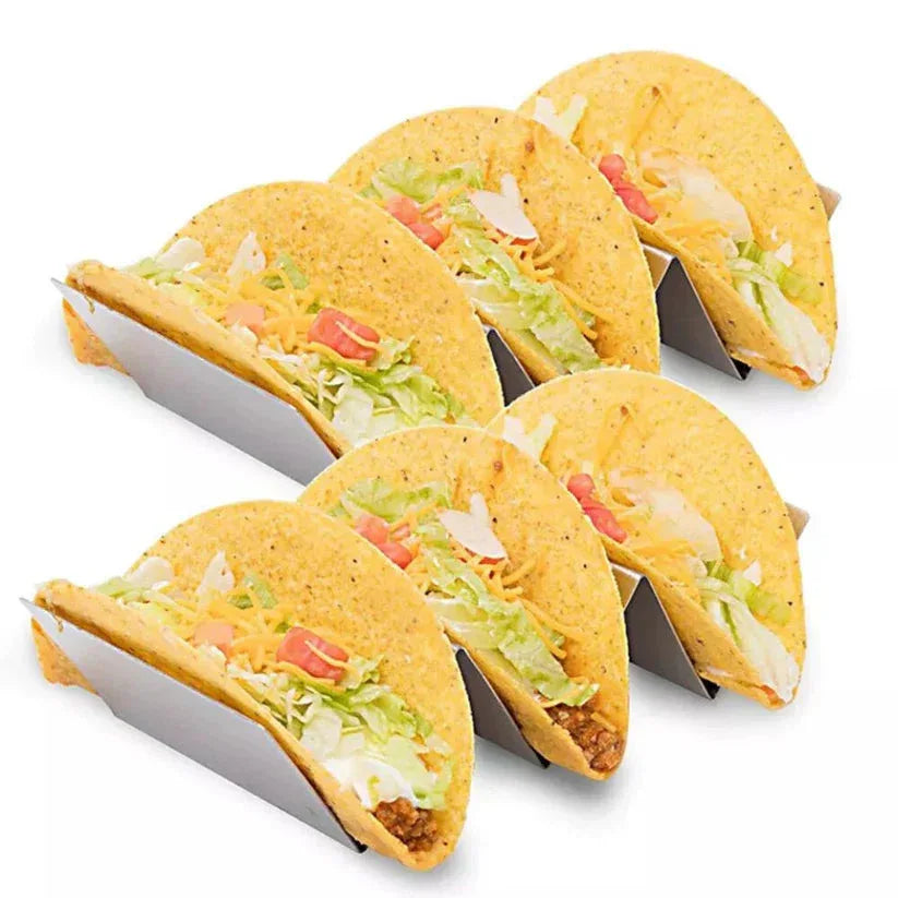 Four hard-shell tacos with fillings on a white background

