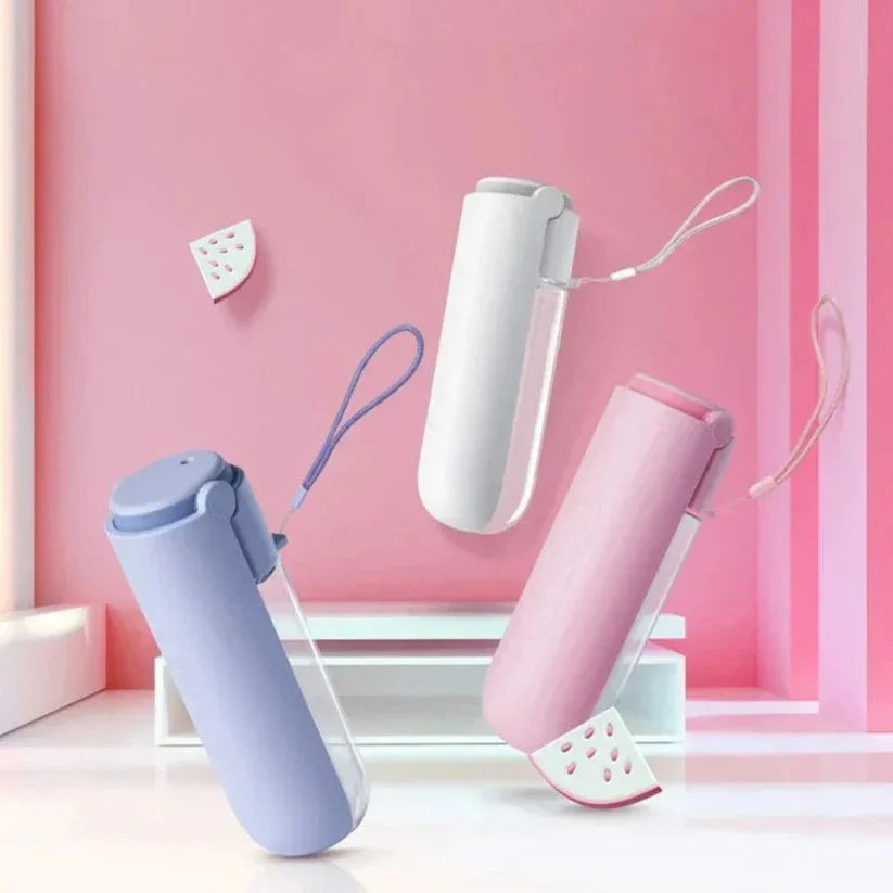 Three portable hand dryers in different colors on a pink background

