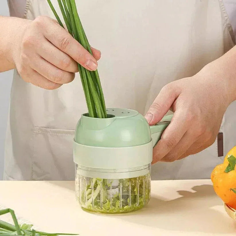 Person using a green vegetable chopper with fresh green vegetables on a light background

