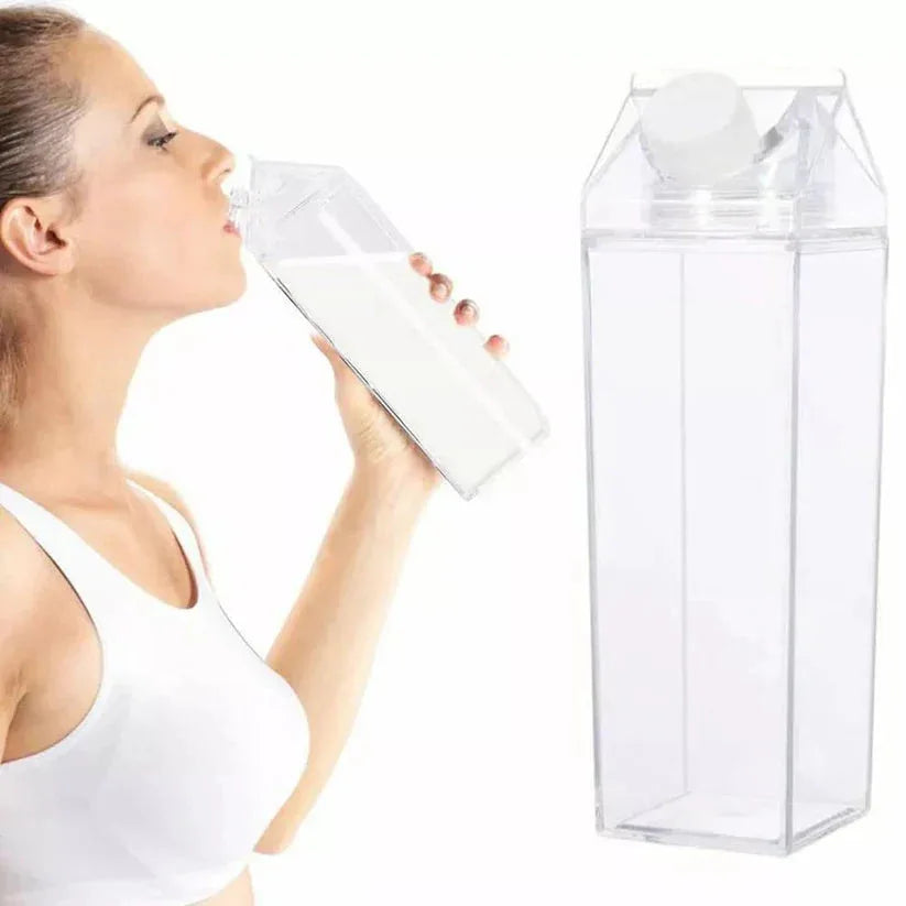 Woman drinking from a clear plastic bottle with a milk carton design on a white background

