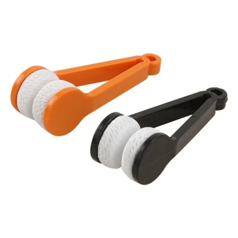 Two pairs of tongs, one orange and white, one black and white, on a white background.

