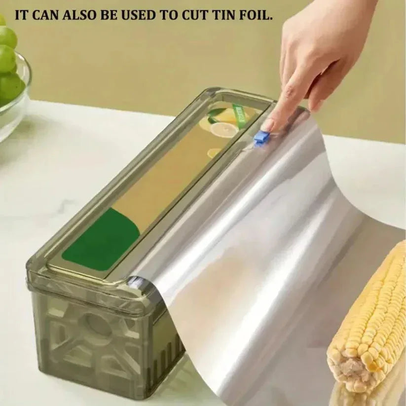 Roll of tin foil being cut with a kitchen tool on a countertop.


