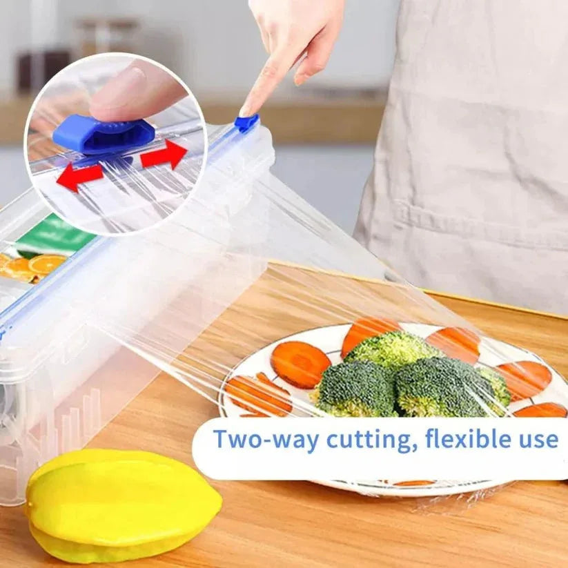 Clear silicone wrap with blue cutting tool on a kitchen counter with vegetables.

