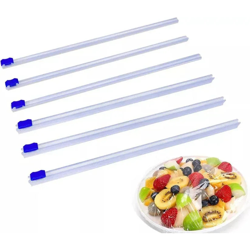 Set of six clear plastic straws with blue caps on a white background, next to a plate of fruit salad.

