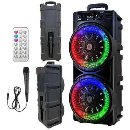 Black portable speaker with RGB lighting, remote control, and microphone on a white background

