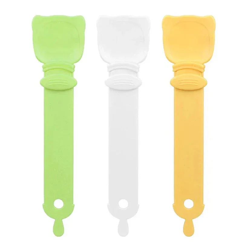 Three silicone tools in green, white, and yellow on a white background


