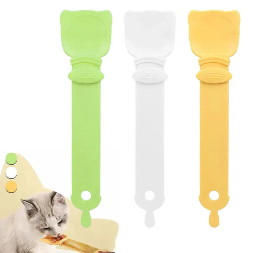 Three colorful cat food scoops with a cat eating from one of them on a white background.

