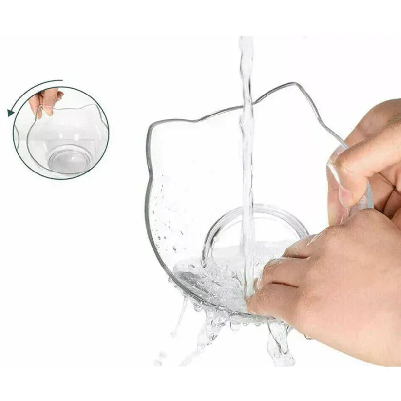 Clear silicone cup with a cat-shaped rim being filled with water on a white background


