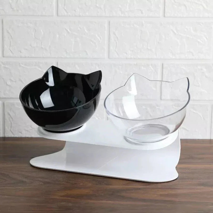 Cat-shaped black and clear bowls on a white brick wall background

