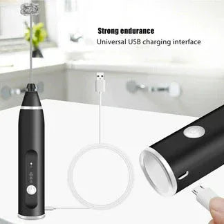 Black handheld device with USB charging cable on a white background

