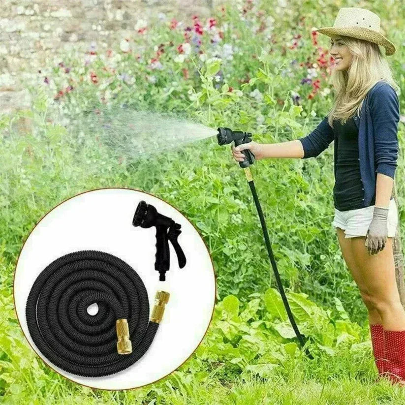 Woman using a garden hose with a spray nozzle in a garden setting

