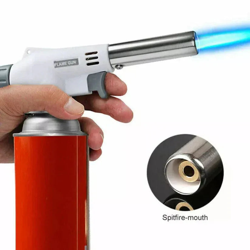 Flame gun with a blue flame being held by a hand, close-up of the nozzle, and a white background.

