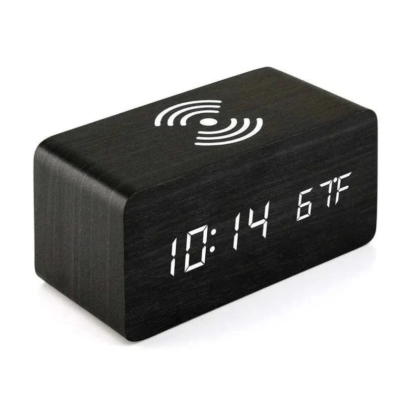 Black digital clock with LED display on a white background


