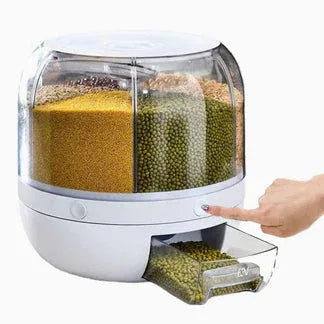 Pet food dispenser with compartments for different types of pet food, being touched by a hand.

