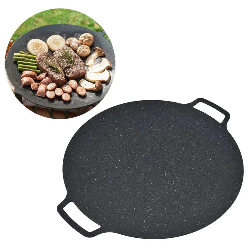 Black cast iron griddle with food on a white background

