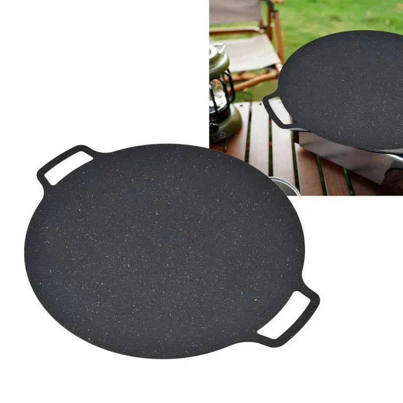 Black griddle pan with speckled surface and handles on a white background.

