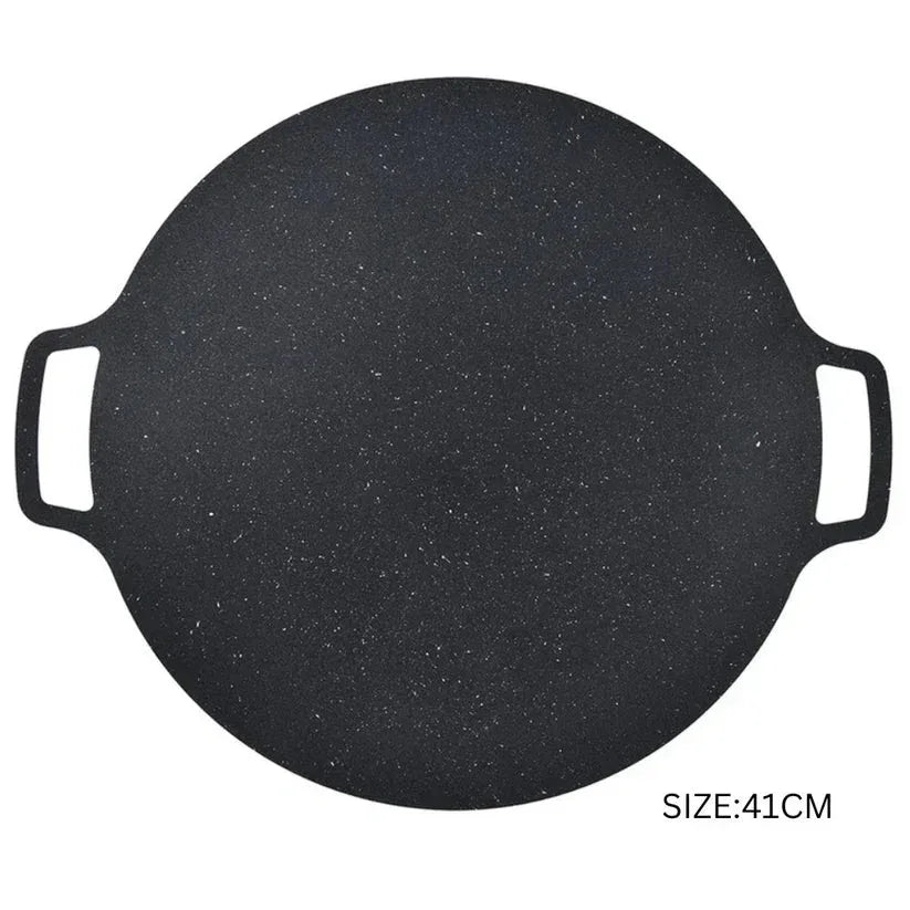 Round black griddle with handles on a white background

