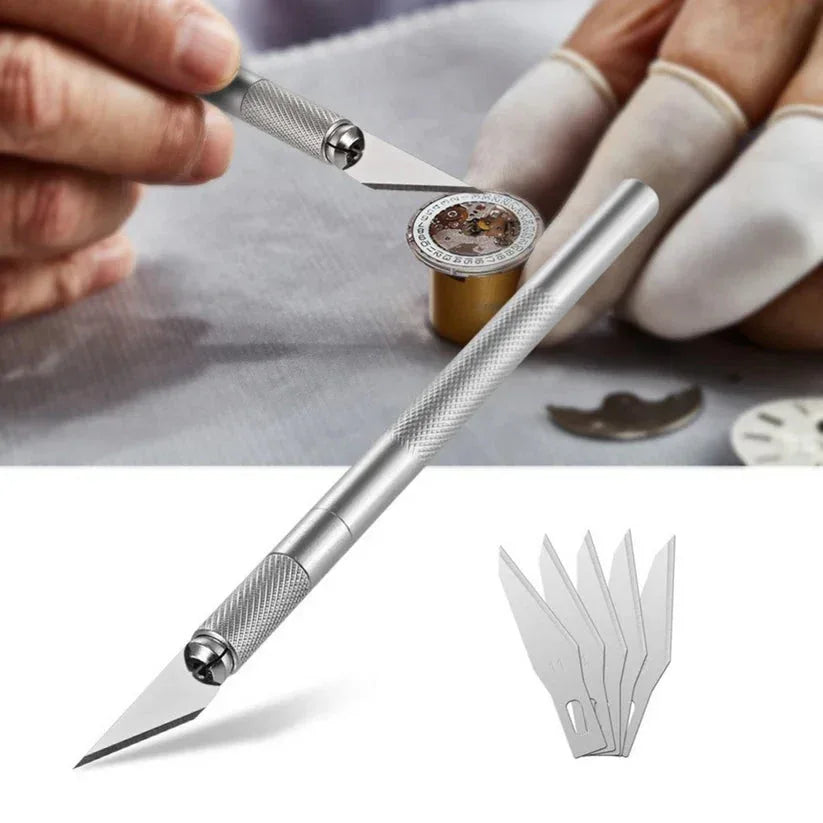 Precision knife tool with interchangeable blades being used on a watch component.

