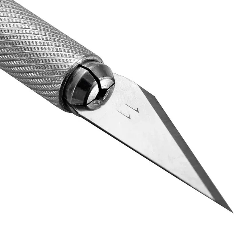 Close-up of a knife with a silver blade and textured handle on a white background

